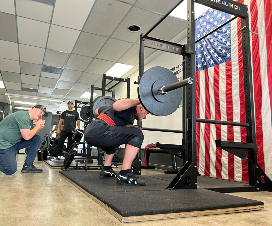 A man squatting a barbell.