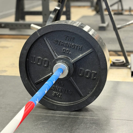 The Strength Co. 100lb bumper plate on barbell