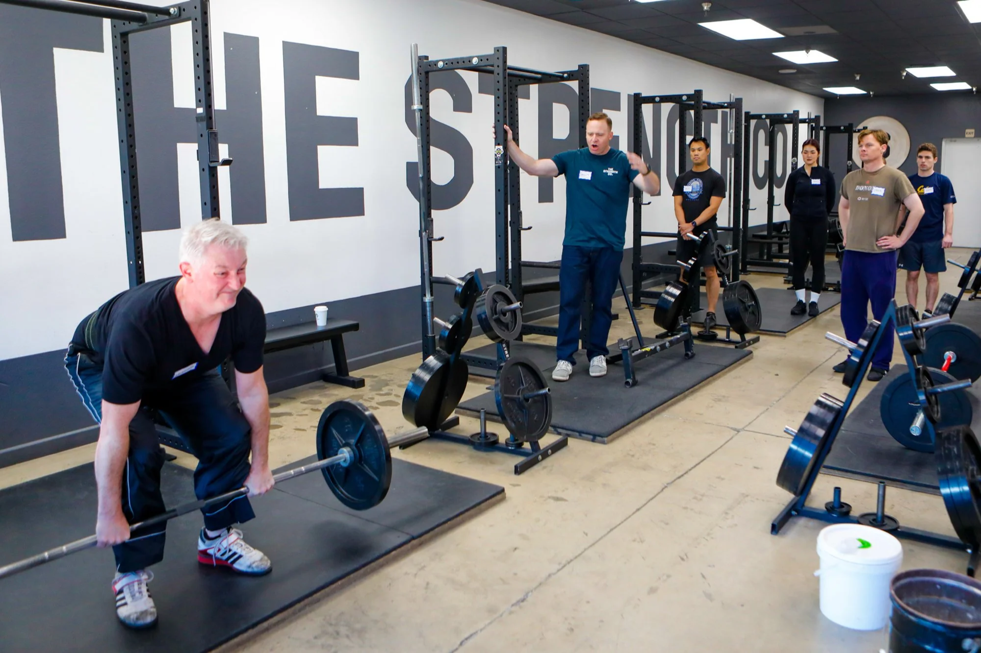 Wide view of The Strength Co. gym floor with squat racks