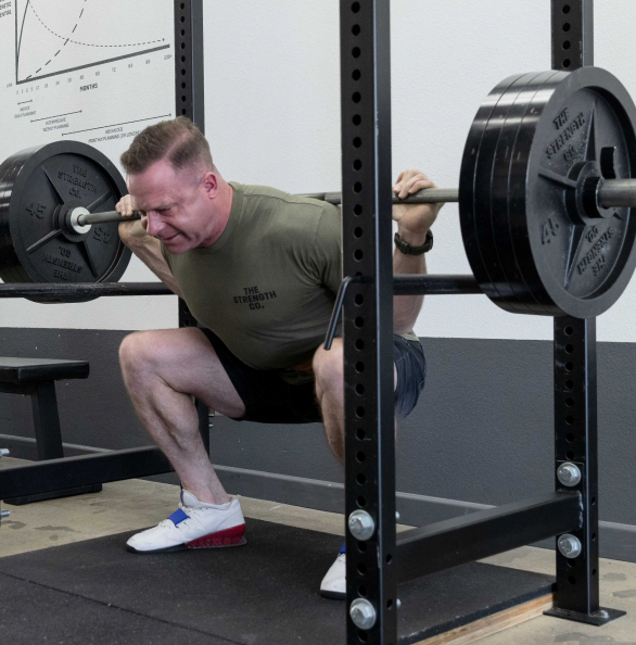 Grant Broggi squatting with a barbell