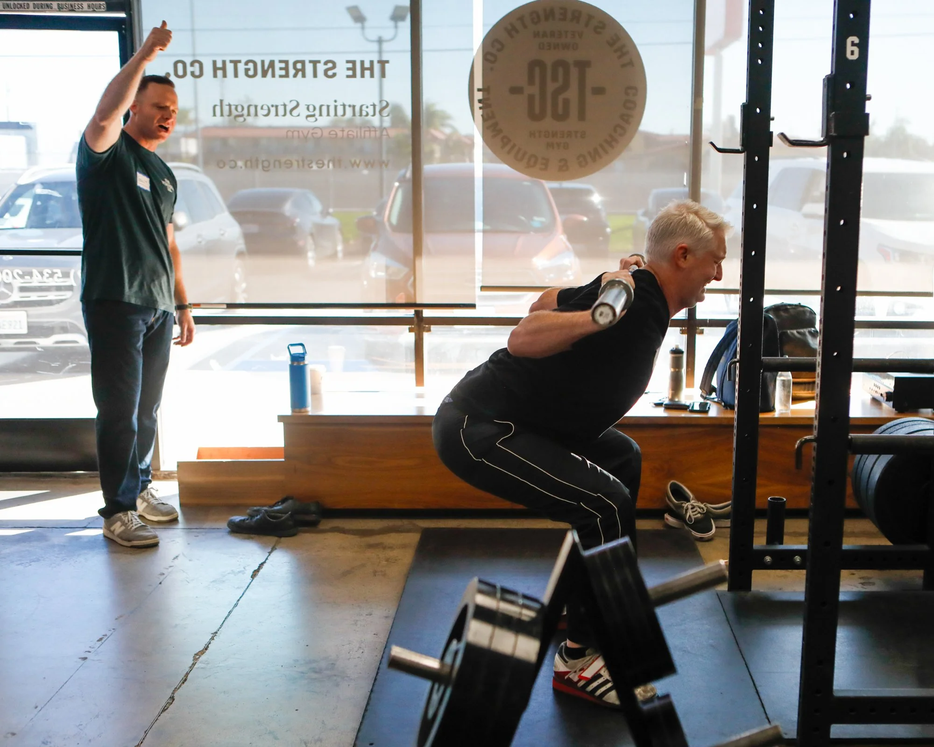 Member squatting at The Strength Co.
