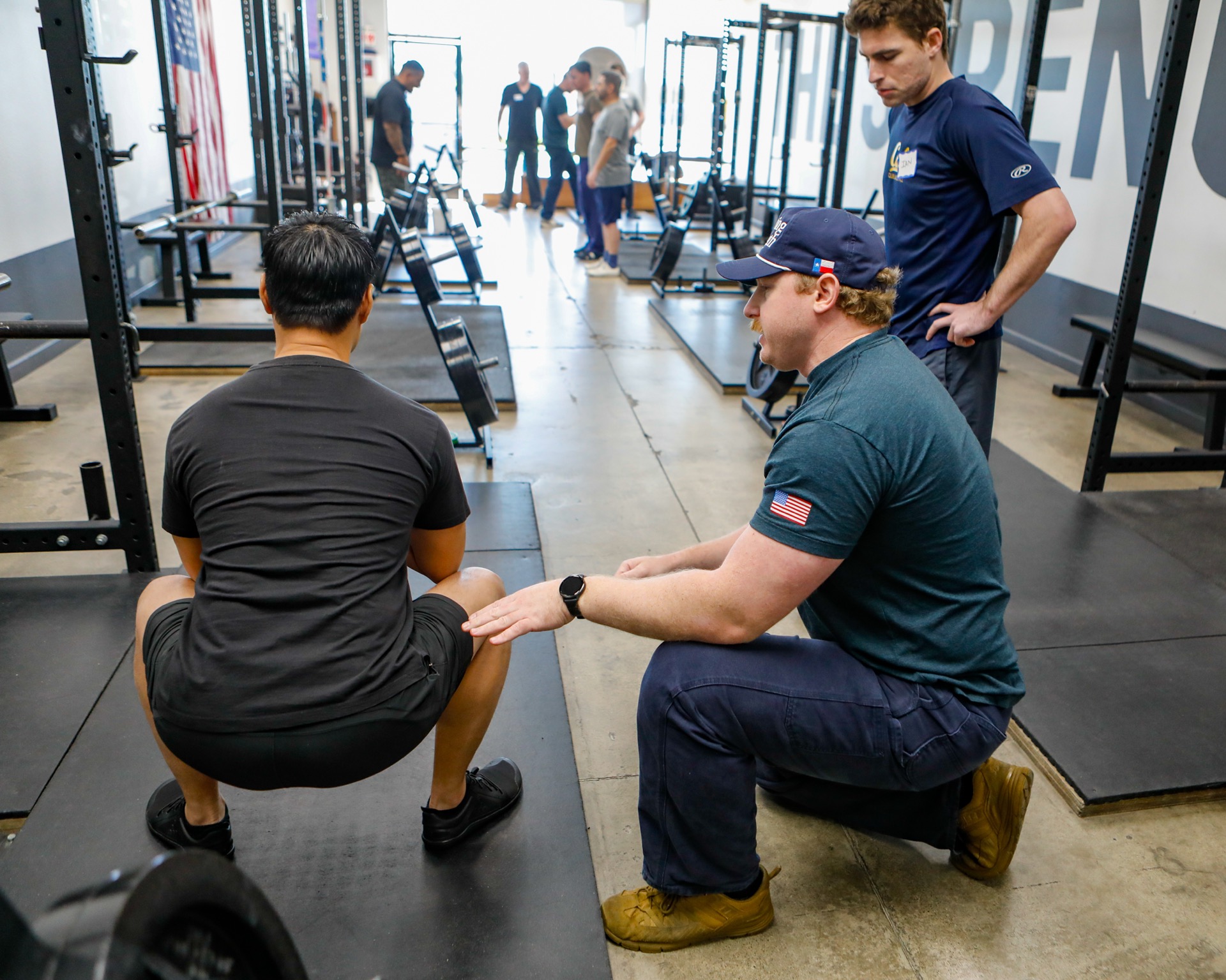 Coaches helping a member with form