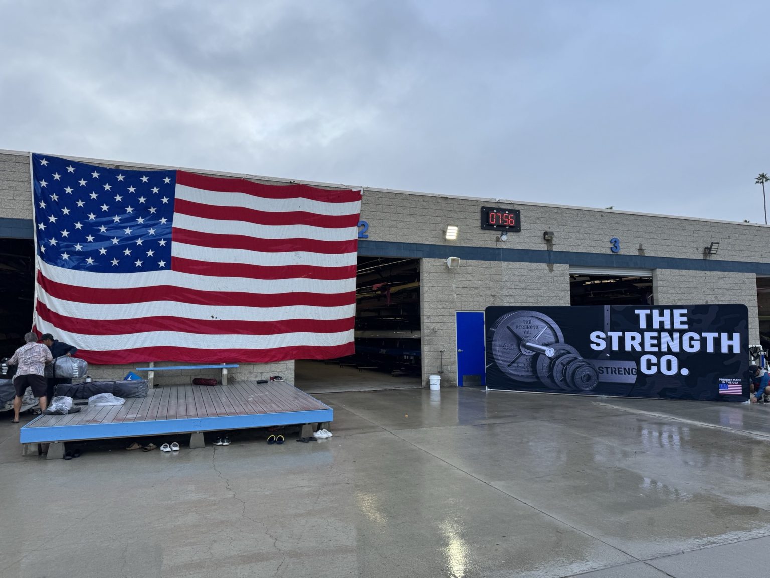 The Strength Co. banner and American flag at the Turkey Pull venue